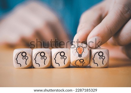 Hand flipping to change human thinking icon to lightbulb lamp glowing icon for creative thinking idea and problem solving concept. Royalty-Free Stock Photo #2287185329