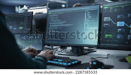 Close Up of a Software Developer Working on a Desktop Computer with Green Screen Mock Up Display. Specialist Typing on Keyboard, Coding and Implementing a New Technical Feature, Working in an Agency