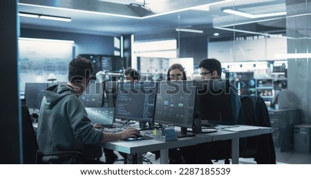 Team of Diverse Multiethnic Software Developers Working on Computers, Sitting Together in One Department. Researching and Providing Technical Support Online Royalty-Free Stock Photo #2287185539