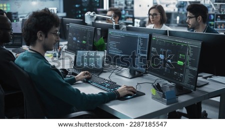 Team of Diverse Multiethnic Software Developers Working on Computers, Programming Advanced Code, Managing Artificial Intelligence Projects Online for Innovative Cybersecurity Technology Company Royalty-Free Stock Photo #2287185547