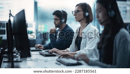 Help Desk Specialist Having a Conversation on a Call, Providing Technical Support to Client Experiencing Computer Hardware and Software Issues. Female Using a Headset to Talk with a Tech Team Royalty-Free Stock Photo #2287185561