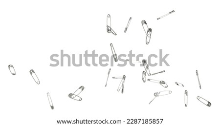 Safety Pin brooch pour fall down, explosion in air. Many safety pin small size splash fly in group floating. White background isolated high speed shutter freeze motion