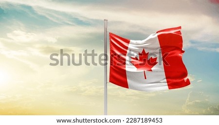 Waving flag of Canada in beautiful sky. Canada flag for independence day. Royalty-Free Stock Photo #2287189453