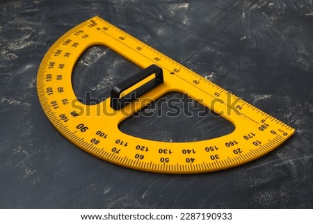 Protractor with measuring length and degree markings on blackboard