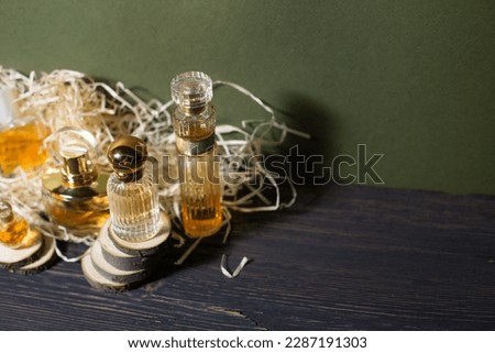 perfume with wood shavings on a black background