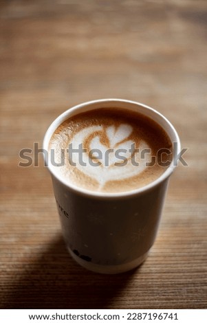 a cup of cappuccino with a picture, coffee with foam