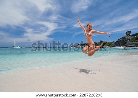 Vacation on the seashore. Happy young woman having fun on the beautiful tropical white sand beach.
