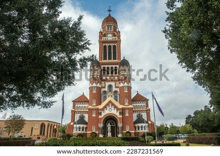 The historic Dutch Romanesque Revival style Cathedral of Saint John the Evangelist or La Cathedrale St-Jean built in 1916 on Cathedral Street in downtown Lafayette, Louisiana, USA Royalty-Free Stock Photo #2287231569