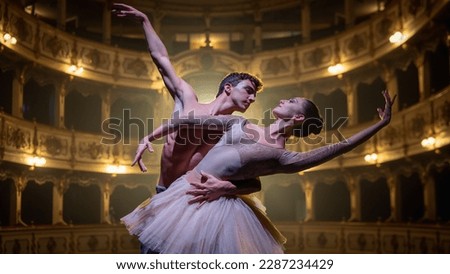 Close Up shot of Two Young Classical Ballet Dancers Performing on Stage of Classic Theatre with Dramatic Lighting. Male and Female Performers Rehearse their Choreography Together Before the show Royalty-Free Stock Photo #2287234429
