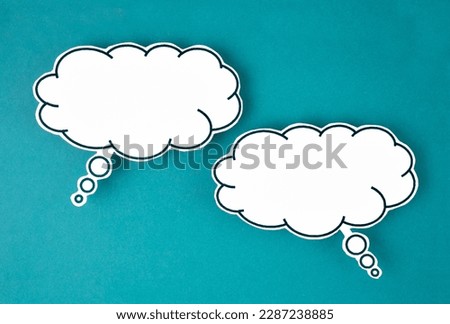 White speech bubble shaped post it note on green background with copy space. Royalty-Free Stock Photo #2287238885