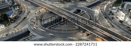 Expressway top view, Road traffic an important infrastructure, Drone aerial view fly in circle, traffic transportation, Public transport or commuter city life concept of economic and energ, transport. Royalty-Free Stock Photo #2287241711