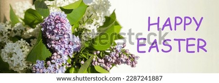happy easter text sign. greeting card. spring flat lay. purple lilac flowers on white background flat lay. blooming flowers in light. web banner