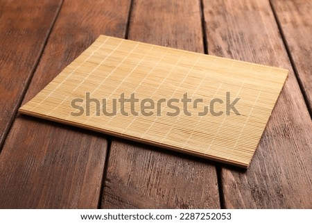 New clean bamboo mat on wooden table Royalty-Free Stock Photo #2287252053