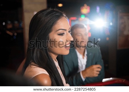 Beautiful and Well Dressed Couple Playing Roulette in the Casino Royalty-Free Stock Photo #2287254805