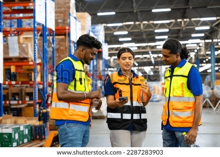 Drink water and looking at mobile phone. Warehouse worker team asian man and woman chat on mobile phone during the break relax time at warehouse factory. Royalty-Free Stock Photo #2287283903