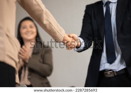 Asian business man shaking hands on a business cooperation agreement. Successful businessmen handshaking after good deal