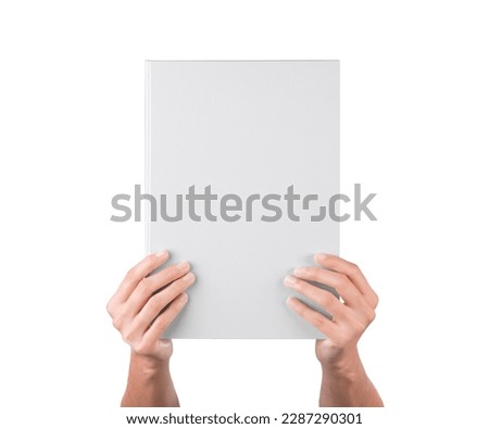 Man holding brochure with blank cover on grey background, top view. Mock up for design