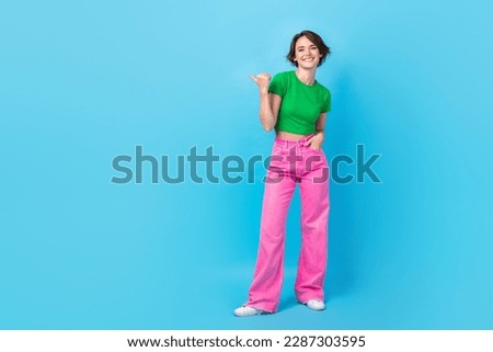 Full body photo of young lady wear stylish glamour bright clothes model indicate finger mockup presentation isolated on cyan color background