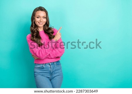 Portrait of gorgeous glad lady wear pink knitted clothes arm direct empty space good news isolated on cyan color background