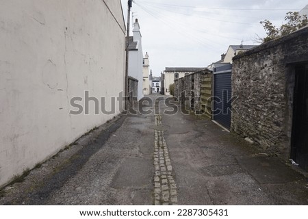 empty alley on a clear day Royalty-Free Stock Photo #2287305431