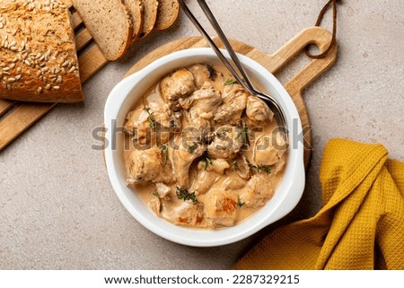 Top view of creamy rabbit stew in a sauce of wine and cream with the thyme and rosemary. 