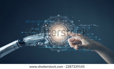 AI technology concept, Machine Learning, Robot hand touching human hand. to connect with global data refers to how humans can create and control artificial intelligence, AI innovation and technology. Royalty-Free Stock Photo #2287339145