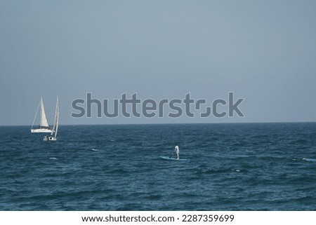 Persons doing paddle in the mediterranean sea
