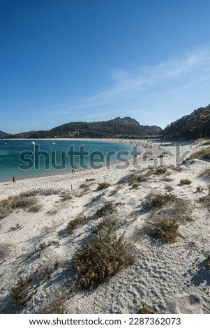 A landscape on the coast with the beach of Rhodes with fine white sand on a summer day with clear blue skies