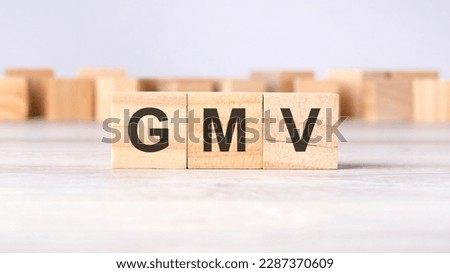 GMV - acronym concept written on wooden cubes or blocks on a light grey background