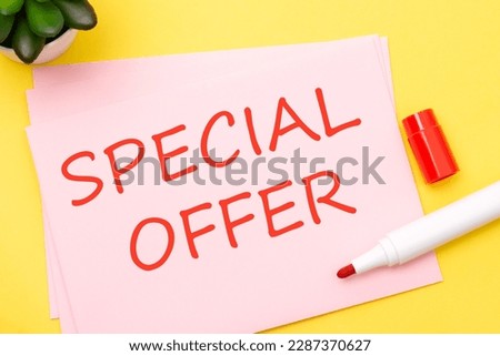 paper with SPECIAL OFFER text stands on a yellow background with red marker, business concept