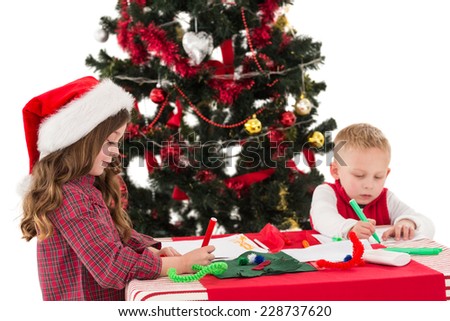 Festive little siblings drawing pictures on white background