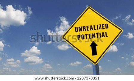 Yellow warning sign with the words "unrealized potential" against the sky Royalty-Free Stock Photo #2287378351