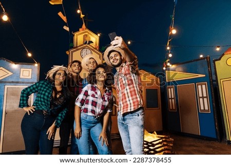 Festa Junina in Brazil. Group of friends taking a selfie during the Festa Junina.