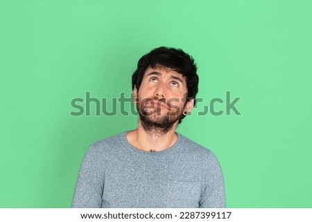 Young caucasian man looking up. Green screen background. Technologies concept. Humor. Business. Networking concept. Social networks.