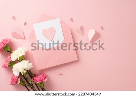 Show your appreciation this Mother's Day with a stunning postcard arrangement featuring pink carnations, and heart-shaped papers on a pastel pink background Royalty-Free Stock Photo #2287404349