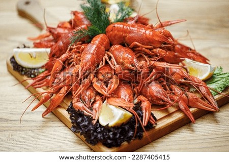 A platter of crayfish with lemon wedges on the side Royalty-Free Stock Photo #2287405415
