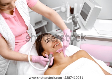 Skin care service,Cosmetology service,Cosmetic procedure,Healthy skin,Hydro-dermabrasion,Rejuvenation treatment,cosmetology procedure. cosmetologist is performing a skincare treatment on a woman Royalty-Free Stock Photo #2287410051