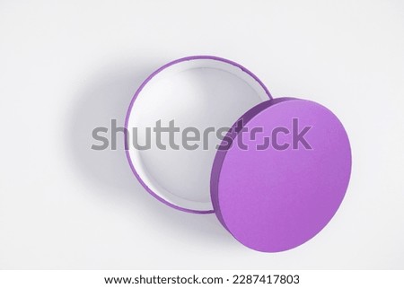 Open purple round gift box isolated on white background. Flat lay, top view, copy space