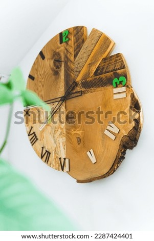 Artistic clock made from tree stump by local carpenter. Unconventional living room decor. Vertical indoor shot. High quality photo