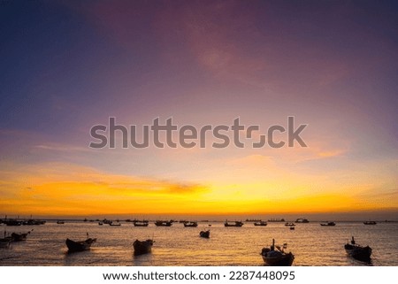 Beautiful cloudscape over the sea, sunrise shot. Lonely boats. Calm sea with sunset sky and sun through the clouds over. Calm sea with sunset sky or sunrise and sun through the clouds over.
