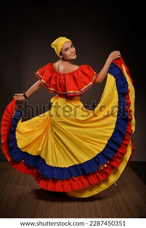 Young Latina Woman in Three-Colored Dress with Flags of Ecuador, Colombia, and Venezuela Royalty-Free Stock Photo #2287450351