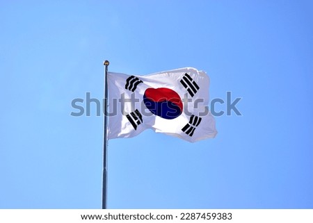 Taegeukgi, the national flag of Korea, flutters in the wind. Royalty-Free Stock Photo #2287459383