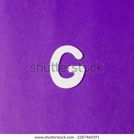Letter G in wood texture - Purple background Royalty-Free Stock Photo #2287460391