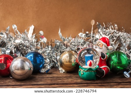 Christmas decorations , Santa Claus and snow ball on wooden background,vintage color tone.