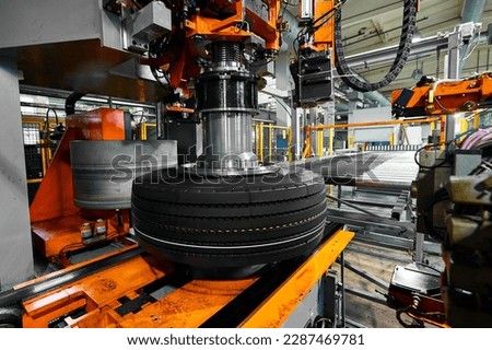 Tire with deep protector and marking on conveyor at plant