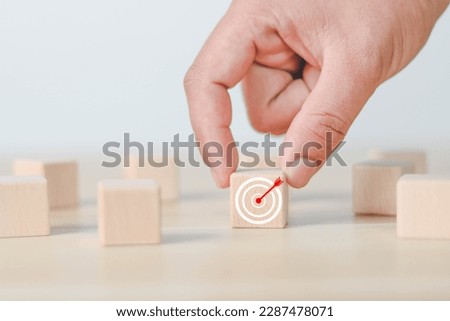 Wooden block drawn with business strategy and action plan, goal setting, business concept, business development concept.