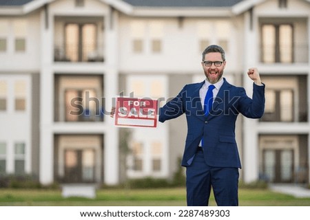 House owner, real estate agents hold sign for sale. Housing estates in the project, buying and selling housing estates. Real estate trading ideas and bank loans for buying and selling houses and land.