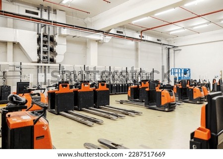 Picture of forklifts on chargers in factory.