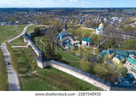Panoramic landscape with the ancient Holy Assumption Pskov-Pechersky Monastery on a sunny May day (aerial view). Pechory. Pskov region, Russia
