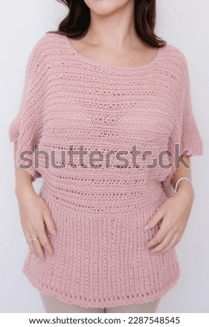 Cute girl wearing some knitted clothing
